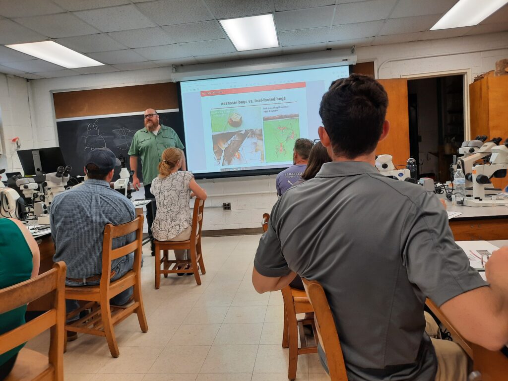Photo showing agents watching a talk about arthropods in a lab setting